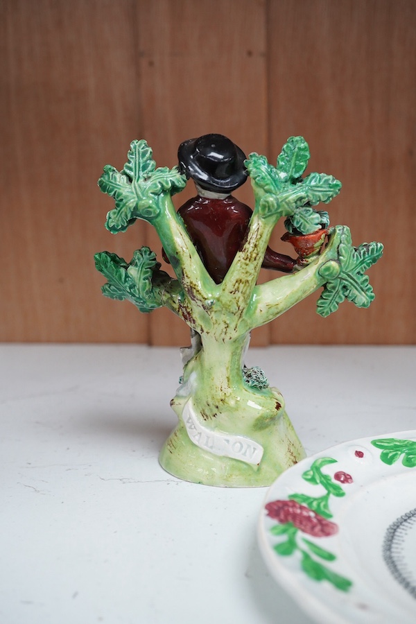 Two early 19th century Walton pearlware figures, the first a man holding a basket flowers, the second a cider costrel, tallest 19.5cm, together with a pearlware nursery plate (3). Condition – some restoration otherwise f